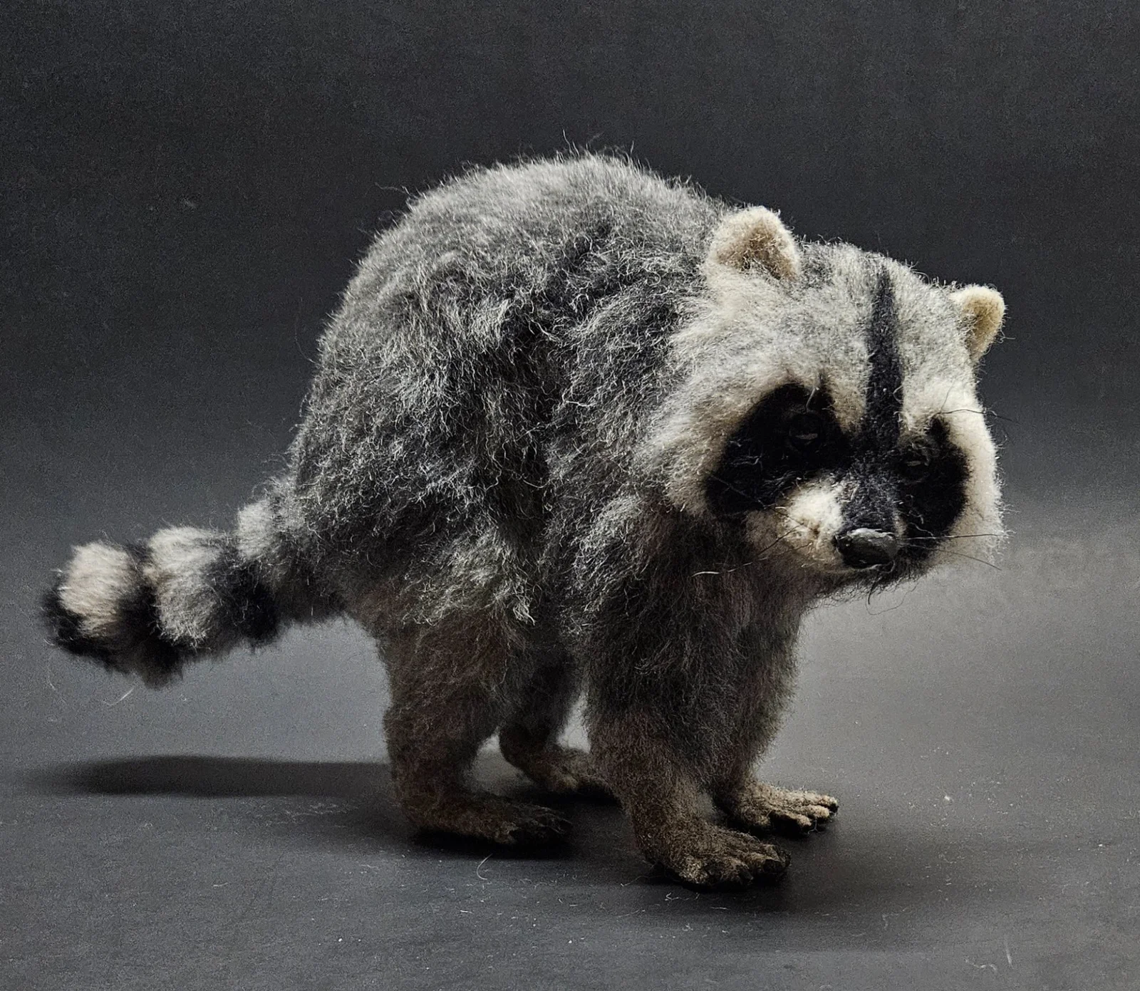Needle-felted raccoon with detailed paws, facial mask and ringed tail by Irina Hughes